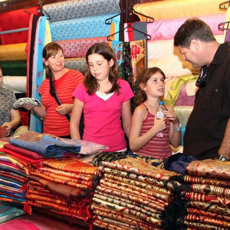 A family buy silk product in Van Phuc Silk Village tours from hanoi