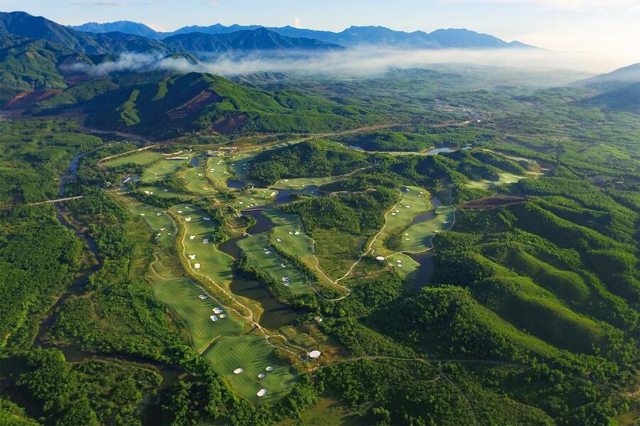 Aerial view of Ba Na Hills Golf Club surrounded by wooded hills near Da Nang