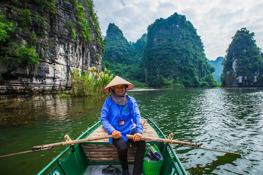 Boat trip through the limestone landscape of Trang An in Ninh Binh