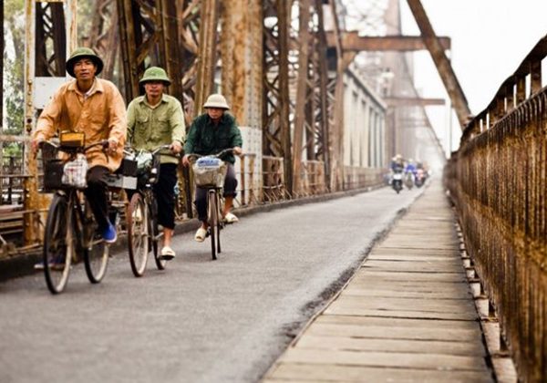 Cycling along Long Bien Bridge Hanoi tour packages