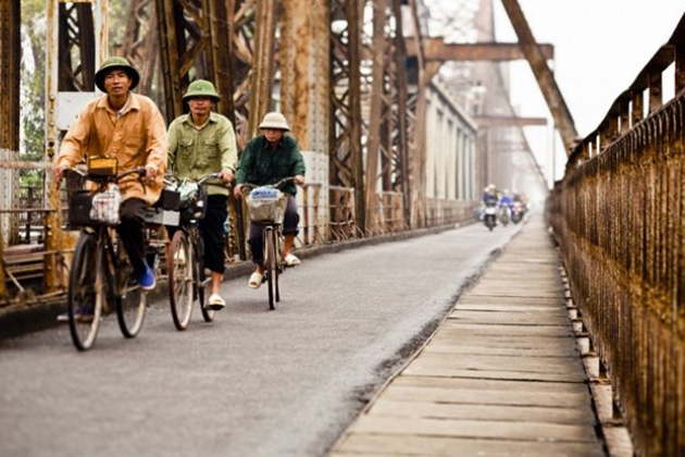 Cycling along Long Bien Bridge Hanoi tour packages