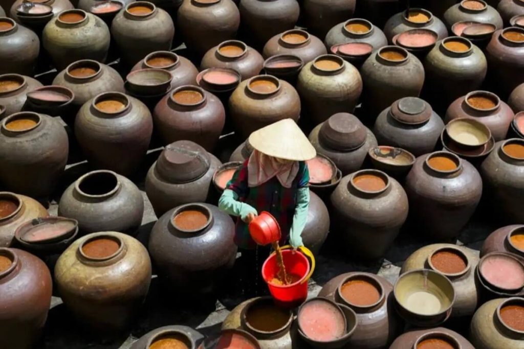 Fermenting soy sauce in ceramic jars at Ban Yen Nhan Soy Sauce Village Hanoi
