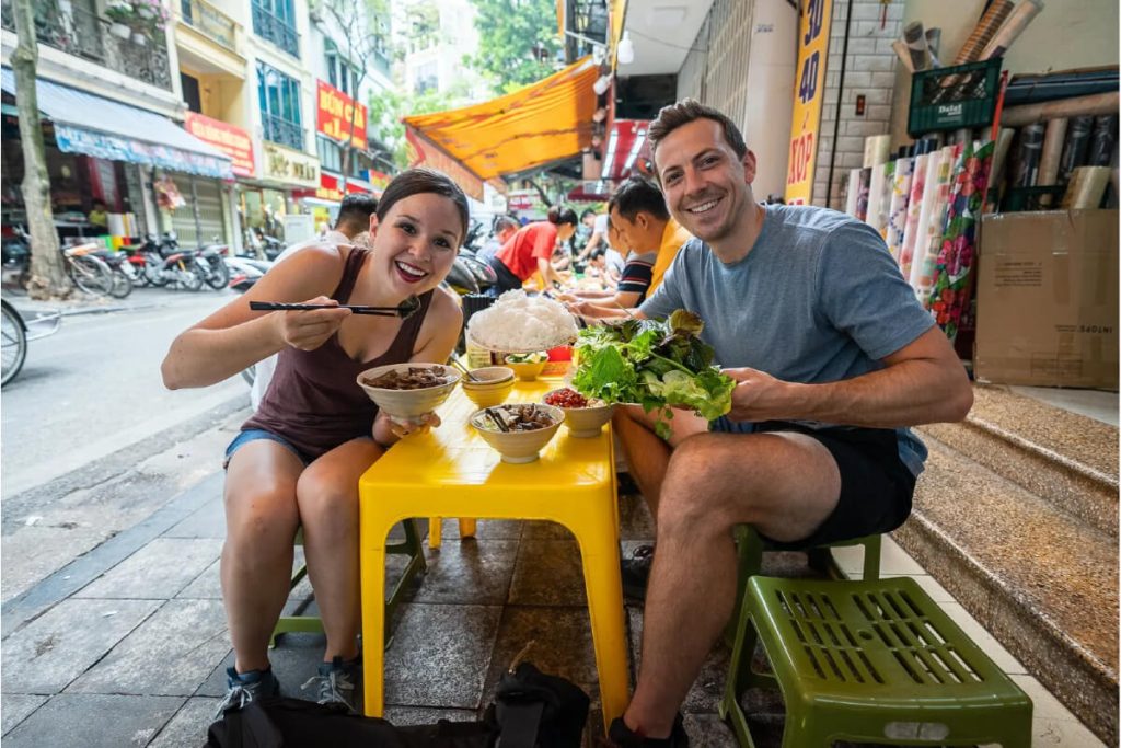 Customer indulge in Vietnamese Street Food - Hanoi Local Tour