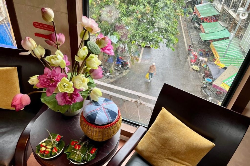 Tourists tasting lotus tea and traditional snacks on Hanoi heritage 5 gates train