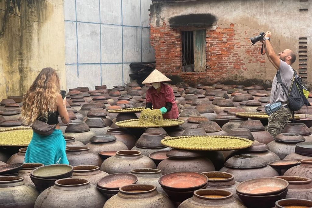 Visitors experiencing the soy sauce making process at Ban Yen Nhan Village