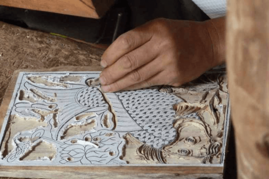 craftsman is doing one of the most difficult step of making Dong Ho picture in countryside trip tour from Hanoi