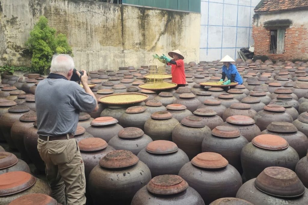 customers take picture in ban yen nhan soy sauce village