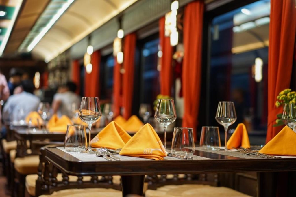 enjoy dinner in the dining carriage on vietnam luxury train