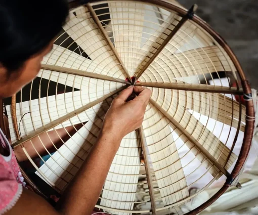 making non la in chuong conical hat village - hanoi day tours