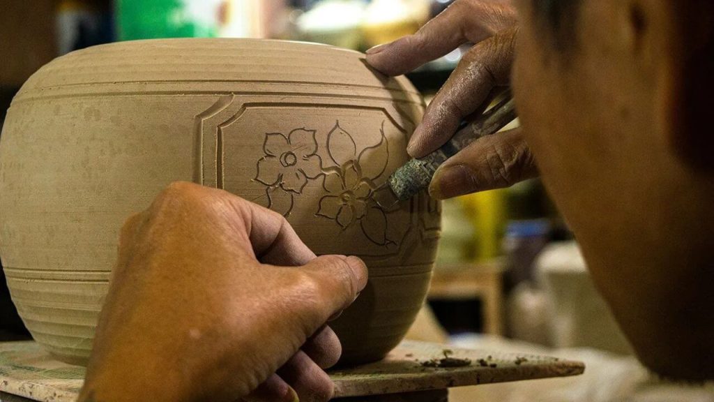 watching artisans make pottery in bat trang village hanoi